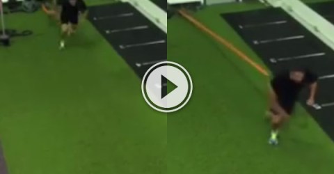 Guy in a gym is running and his bungee cord snaps making him dance in pain.