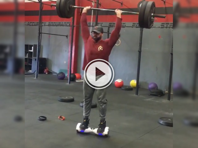 Can you balance on a hoverboard and lift weights? This guy can! (Video)