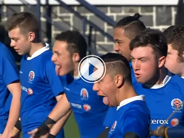 Boys in blue jerseys stick out their tongues and stare angrily at someone or something!