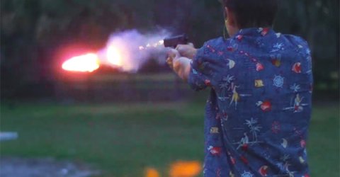 Man shooting out a fire bullet from a gun