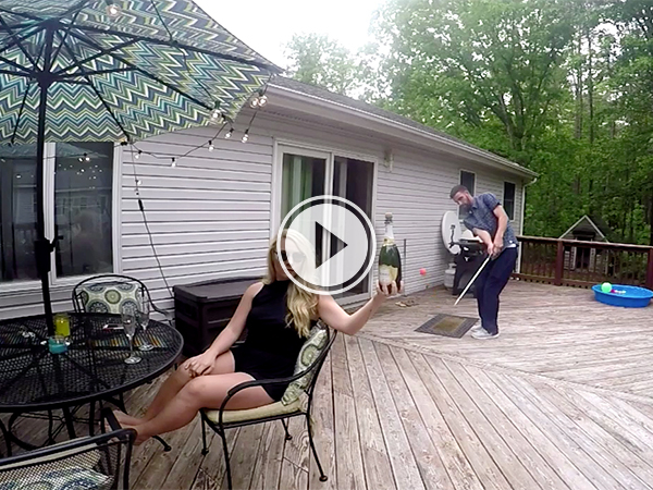 Video grab of a guy popping champagne with a golf ball