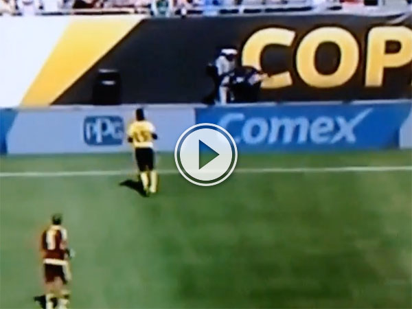 Two soccer players approach the sideline.