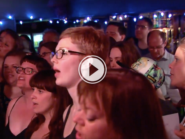 A group of people singing.