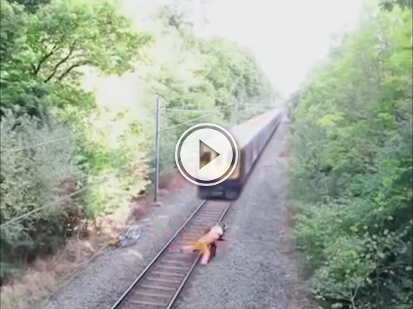 Drunk guy has trouble with tracks and narrowly avoids a train (Video)