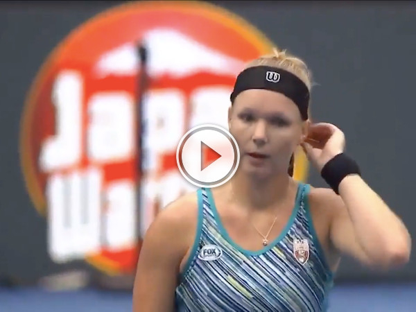 She goes for the serve, and derps it of her head (Video)