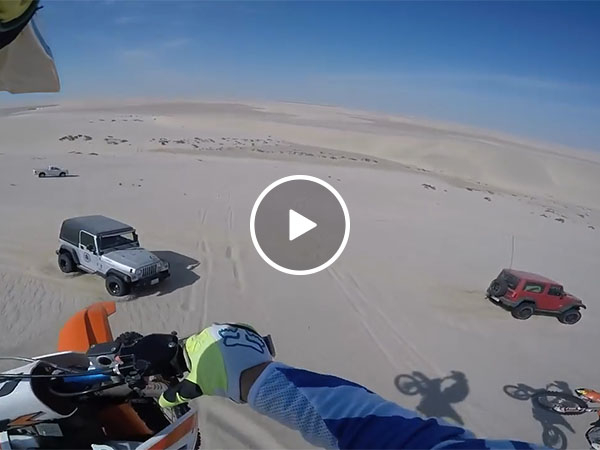 Guy accidentally hits jeep after jumping 100ft off sand dune (Video)