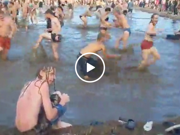 Guy emerges from festival water for his... precious (Video)