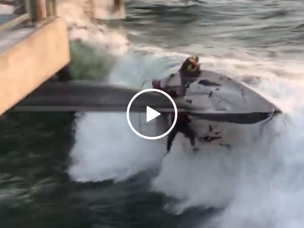 Terrifying moment sailboat capsizes into pier (Video)