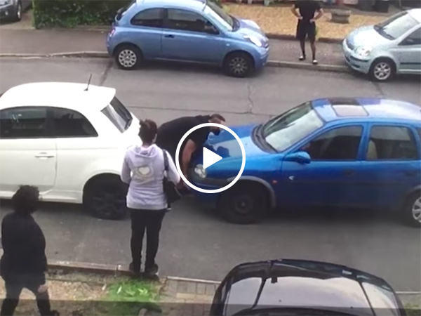 Strongman moves car in the middle of traffic dispute