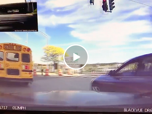 Car tries to pass school bus, running himself onto barrier (Video)
