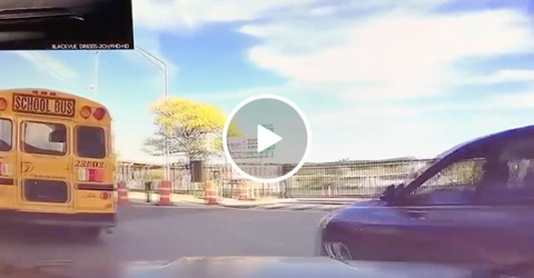 Car tries to pass school bus, running himself onto barrier (Video)
