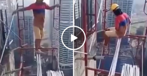 Construction worker building sky scraper without safety gear