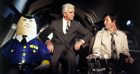 Leslie Nielsen and Robert Hays in the cockpit of the movie, "Airplane!" (1980)